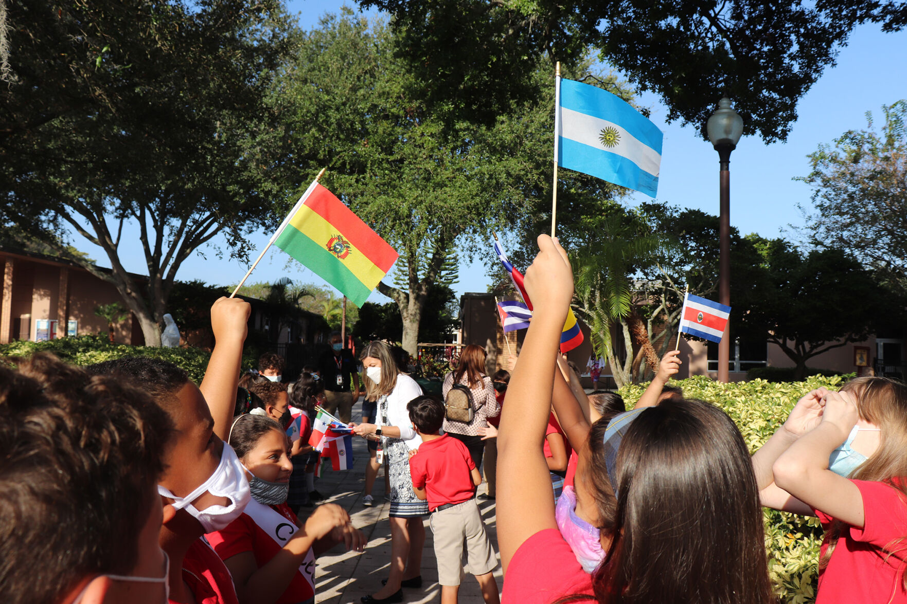 St. John Vianney Catholic School students wave flags